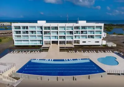 a large white building with a pool in front of it at Apto 411 puerto velero in Tubará