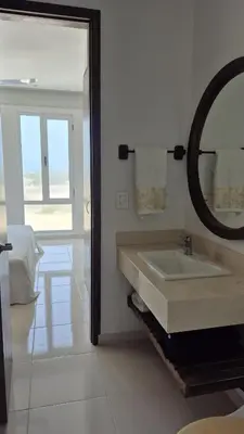 a white bathroom with a sink and a mirror at Apto 411 puerto velero in Tubará