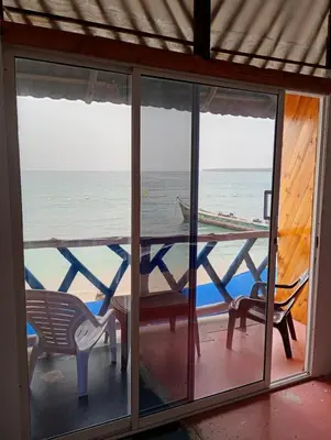 a screened in porch with a view of the ocean at Paraíso de corales in Playa Blanca