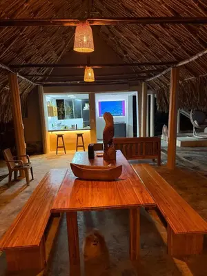a wooden table with a bird statue on top of it at Cabaña de Lujo en Isla Fuerte VIP in Isla Fuerte