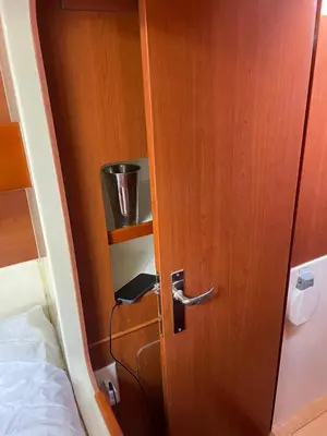 a wooden door in a room next to a bed at Catamaran in Cartagena Bay in Cartagena de Indias