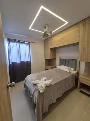 a bedroom with a bed with a white bow on it at Precioso apartamento cerca del mar in Cartagena de Indias