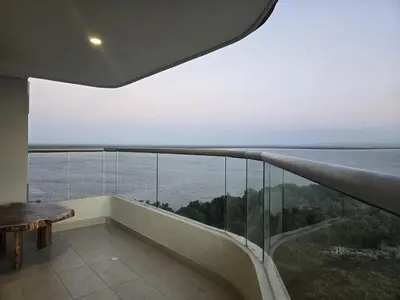 a room with a balcony with a view of the ocean at Brand New, Perfectly Located 2-2 in CieloMar! in Cartagena de Indias