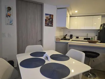 a kitchen with a table and chairs in a kitchen at Brand New, Perfectly Located 2-2 in CieloMar! in Cartagena de Indias