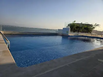 a large swimming pool with blue water on a building at Brand New, Perfectly Located 2-2 in CieloMar! in Cartagena de Indias