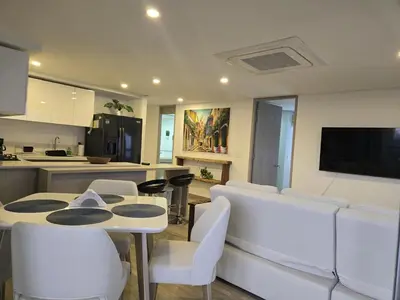 a living room with a table and white chairs at Brand New, Perfectly Located 2-2 in CieloMar! in Cartagena de Indias