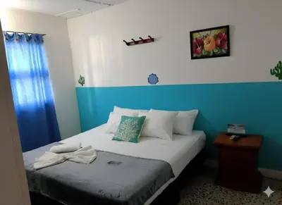 a bedroom with a bed with a blue wall at Hotel Montecarlo by Croma in Santiago