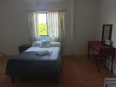 a bedroom with a bed and a desk and a window at Hotel Montecarlo by Croma in Santiago