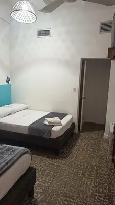 a room with two beds in a room at Hotel Montecarlo by Croma in Santiago