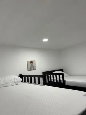 a bedroom with two beds and two chairs at Coral del Mar 1 in Tolú