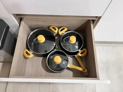 four pairs of frying pans in a drawer at Luxury Apartment Suite Lake View 2 min Airport in Cartagena de Indias