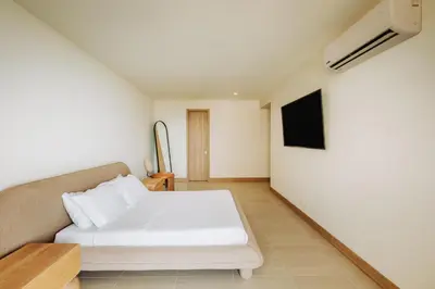 a bedroom with a bed and a tv on the wall at Morros EOS Manzanillo del mar in Cartagena de Indias