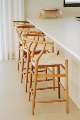 a row of wooden chairs at a kitchen counter at Morros EOS Manzanillo del mar in Cartagena de Indias