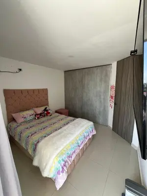 a bedroom with a bed with a stuffed animal on it at Sebastián torres in Barranquilla