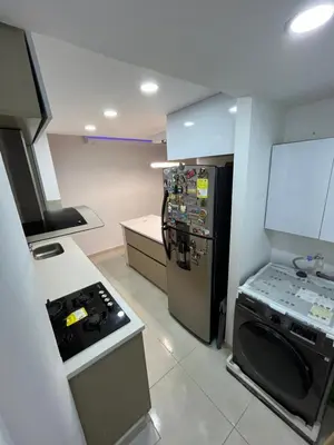 a kitchen with a stove and a black refrigerator at El encanto de Cartagena in Cartagena de Indias