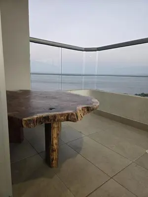 a wooden bench in front of a large window at Brand New Perfectly Located 2bedroom in CieloMar in Cartagena de Indias