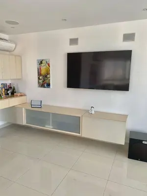 a living room with a large television on a wall at Apartamento en Riomar a pocas cuadras CC Buenavista in Barranquilla