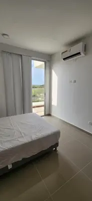 a white bedroom with a bed and a window at Apto Doral Suite Zona exclusiva Cartagena in Cartagena de Indias