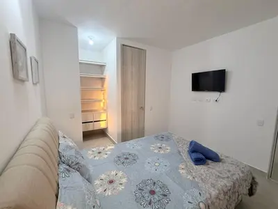 a bedroom with a bed and a tv on the wall at Hermoso apartamento en Manzanillo del Mar in Cartagena de Indias