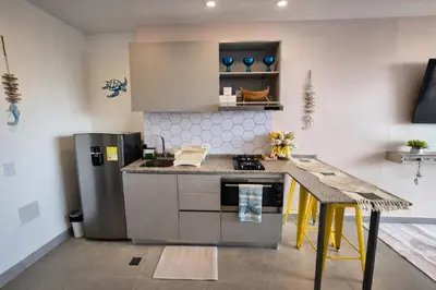 a kitchen with a stove and a counter top at Apto nuevo Frente al Mar con Piscina Wifi cerca aeropuerto in Santa Marta