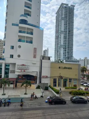 a city with tall buildings and cars on a street at Apt Edificio los Delfines Playa in Cartagena de Indias