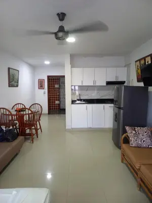 a living room with a couch and a table and chairs at Apt Edificio los Delfines Playa in Cartagena de Indias