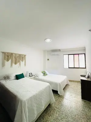 a bedroom with two beds and a window at Two Bedroom Apt in Cartagena de Indias