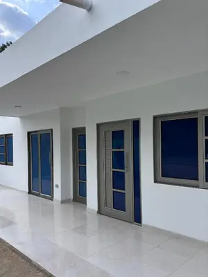 a row of doors on a white building at Apartamento familiar en coveñas cerca del mar in Coveñas
