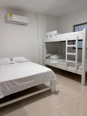 a white bunk bed in a white room at Apartamento familiar en coveñas cerca del mar in Coveñas