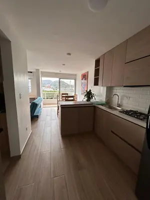 a kitchen with wooden floors and a large window at New apartment 5 minutes from the beach in Cartagena de Indias