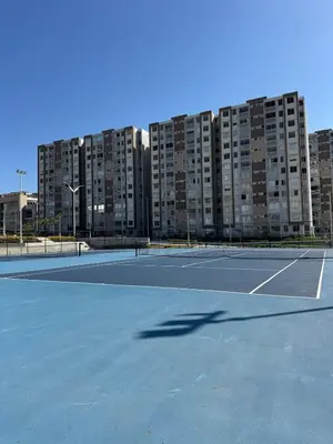 a tennis court in front of a large building at Apartamento exclusivo y nuevo en el norte de Barranquilla in Barranquilla