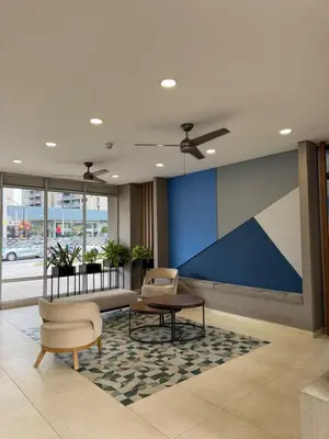 a lobby with two chairs and a table in a building at Apartamento exclusivo y nuevo en el norte de Barranquilla in Barranquilla
