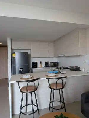 a kitchen with two bar stools and a counter at Manzanillo Morros Kai 526 in Cartagena de Indias