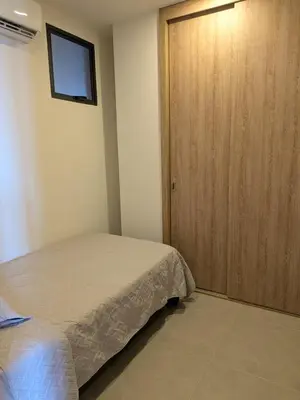 a bedroom with a bed and a wooden door at Manzanillo Morros Kai 526 in Cartagena de Indias