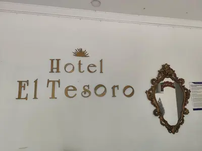 a sign for a hotel el paso on a wall at Hotel El Tesoro in Barranquilla