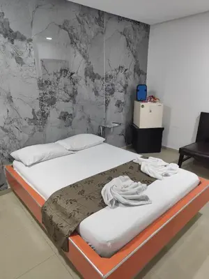 a bed in a room with a wall at Hotel El Tesoro in Barranquilla