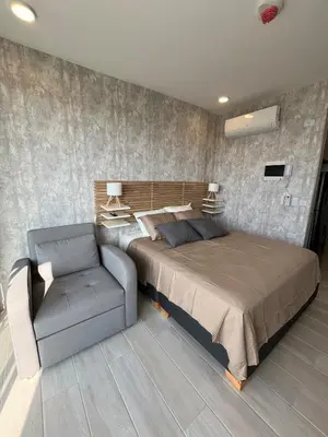 a bedroom with a bed and a couch and a chair at Terraza del Mar in Santa Marta