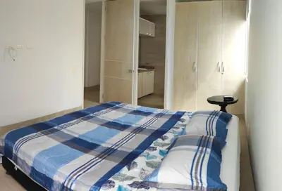 a bedroom with a bed with a blue and white blanket at Apto Coveñas in Coveñas