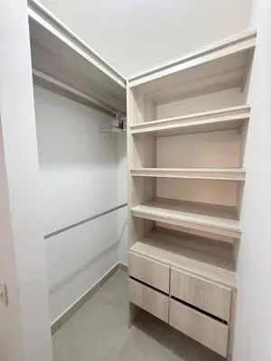 a walk in closet with white walls and wooden shelves at Apartamento Hermoso en Manzanillo del Mar Cartagena in Cartagena de Indias