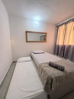 a bedroom with two beds and a mirror at Apartamento Hermoso en Manzanillo del Mar Cartagena in Cartagena de Indias