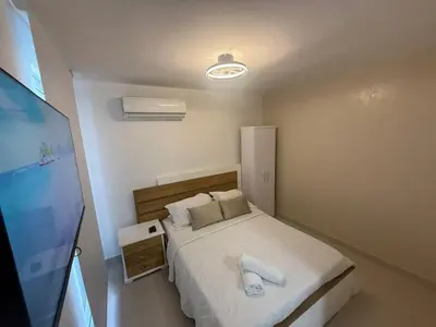 a bedroom with a bed with two towels on it at Apartamento con cercania al Mar y centro historico in Cartagena de Indias
