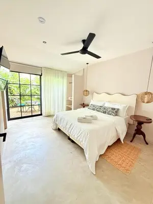a bedroom with a bed and a ceiling fan at Private loft near the airport with fast WiFi in Cartagena de Indias
