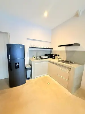 a small kitchen with a refrigerator in a room at Private loft near the airport with fast WiFi in Cartagena de Indias