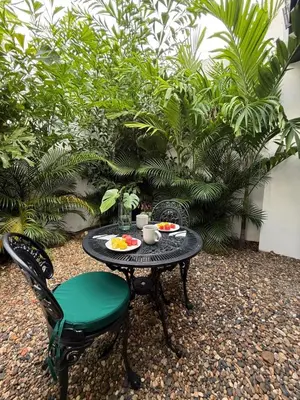 a table and a chair with plates of food on it at Private loft near the airport with fast WiFi in Cartagena de Indias