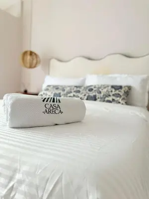 a white bed with two pillows on top of it at Private loft near the airport with fast WiFi in Cartagena de Indias