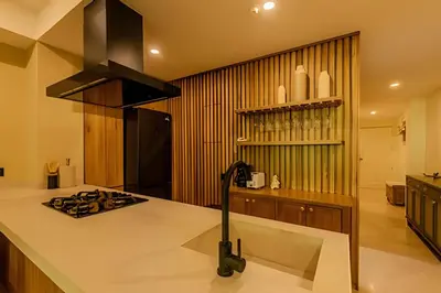a kitchen with a counter and a stove top oven at Colonial Elegance in Historic Center /Pool in Cartagena de Indias
