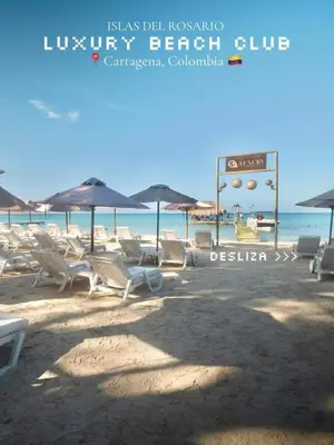 a group of chairs and umbrellas on a beach at apartamentos amoblados o hotel en Cartagena para arriendo por día desde 330 mil pesos hasta 600 mil mil pesos colombianos in Cartagena de Indias