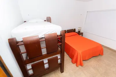 a bedroom with two bunk beds and an orange pillow at Country cabin, Coveñas in Coveñas