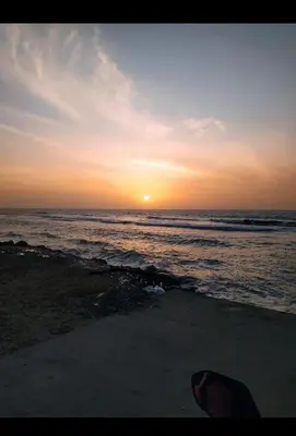 a sunset on the beach with the ocean at Tefi beach in Puerto Colombia