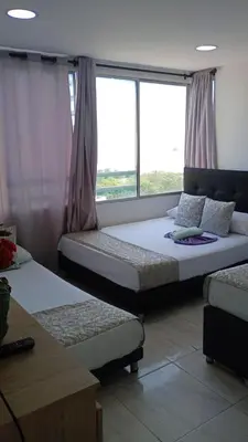 two beds in a room with a window at Cartagena Sotavento Laguito in Cartagena de Indias